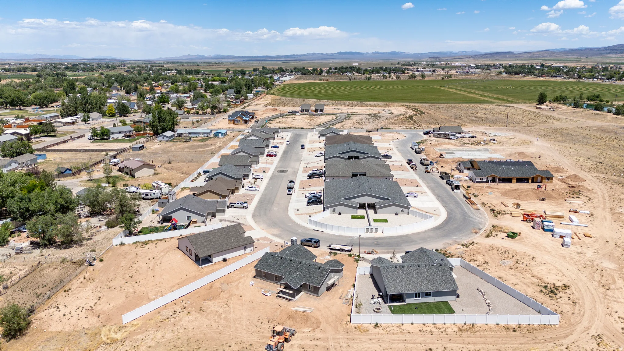 Established subdivision with a cul-de-sac, surrounded by developing properties and open land