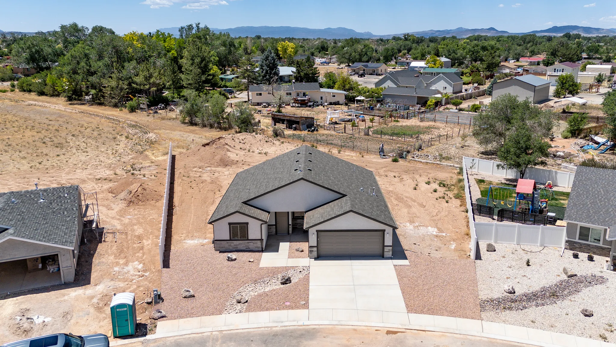 Contemporary ranch-style residence featuring a prominent front-facing garage