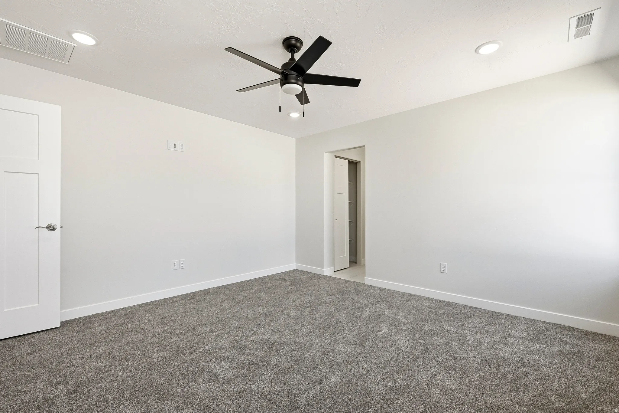 Neutral wall tones, recessed lighting, ceiling fan with light fixture, gray carpeting, and white trim