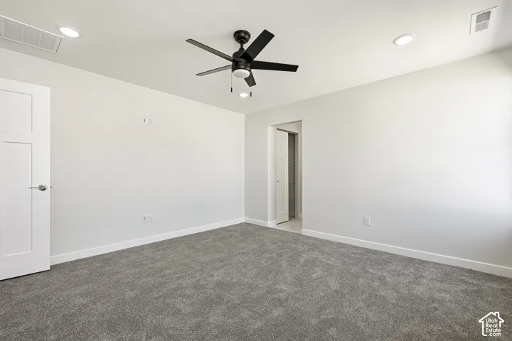Neutral wall tones, recessed lighting, ceiling fan with light fixture, gray carpeting, and white trim