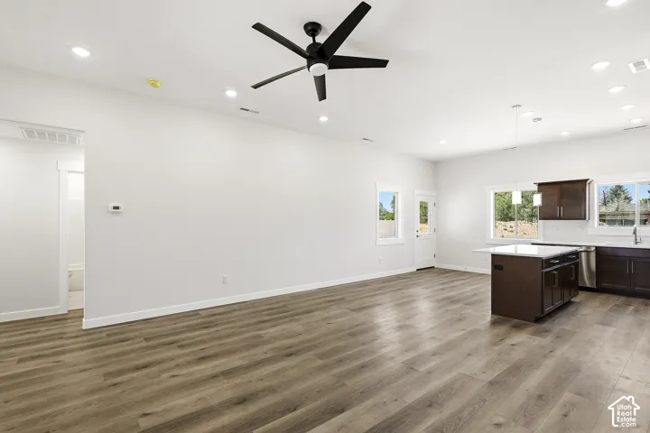 Spacious living area featuring wood-finish flooring, recessed lighting, and a modern ceiling fan