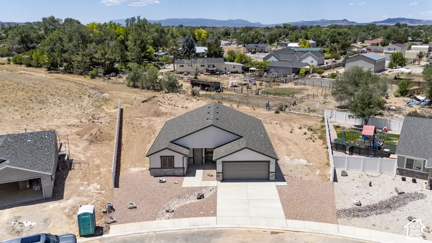 Contemporary ranch-style residence featuring a prominent front-facing garage