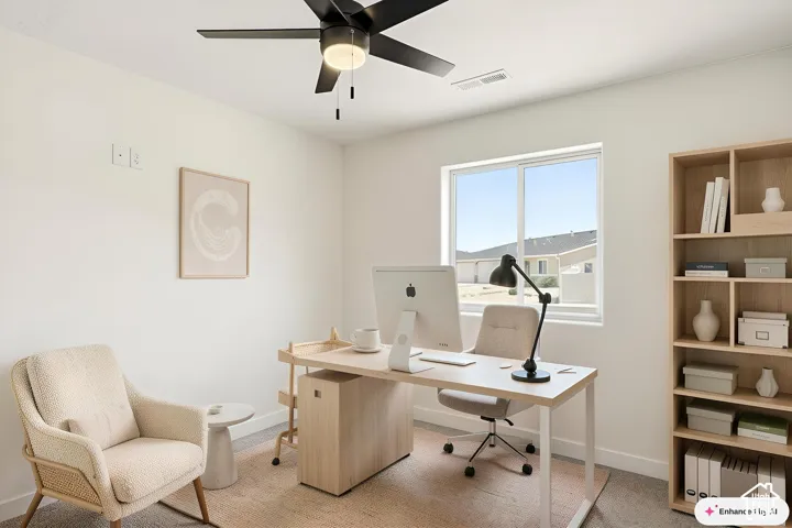 Bright interior space featuring a ceiling fan with integrated lighting, a large window, and light-toned walls