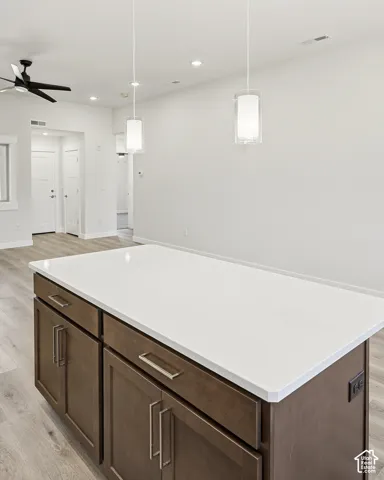 Kitchen island with a white countertop and wood-finish cabinetry