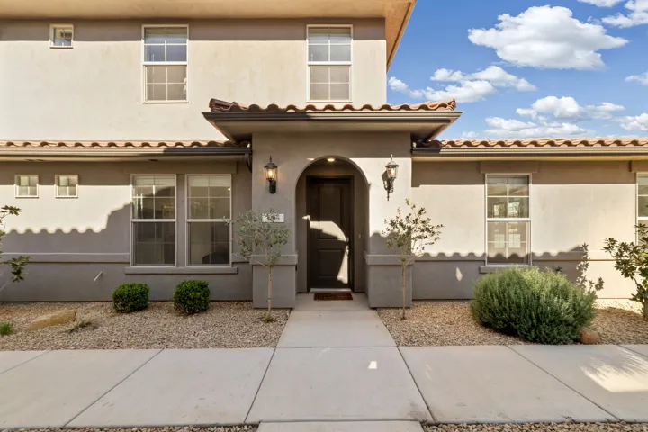 View of front facade with stucco siding and a tile roof