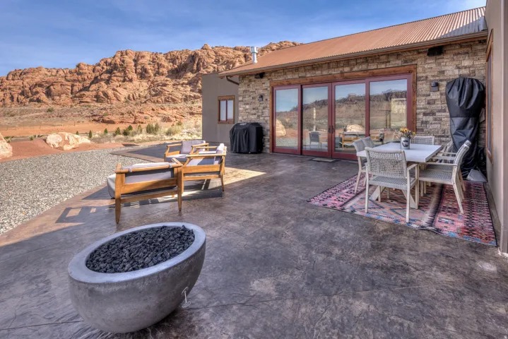 View of patio / terrace featuring outdoor dining area, french doors, area for grilling, a mountain view, and an outdoor fire pit
