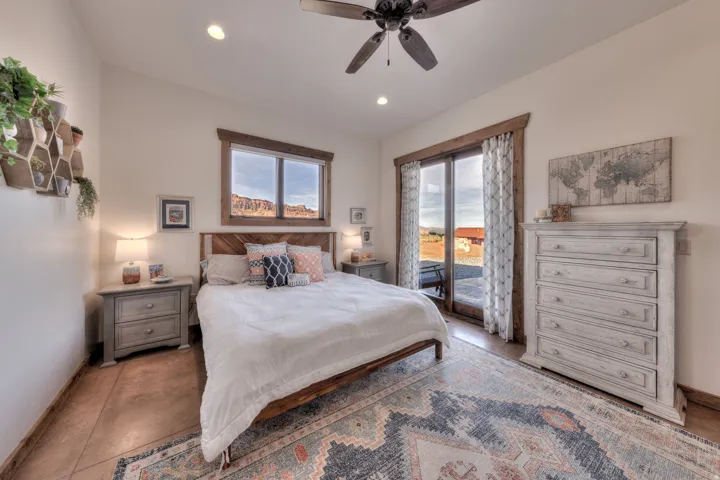 Bedroom featuring access to exterior, a ceiling fan, multiple windows, and recessed lighting