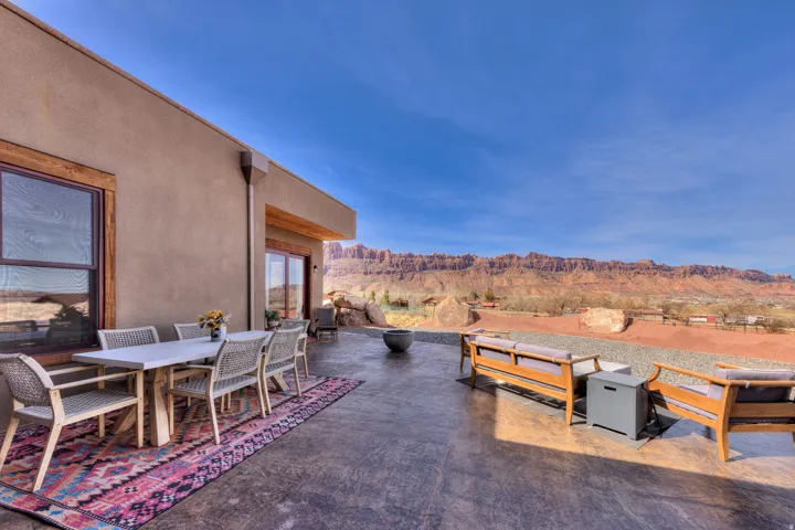 View of patio / terrace featuring outdoor dining space, a mountain view, and a fire pit
