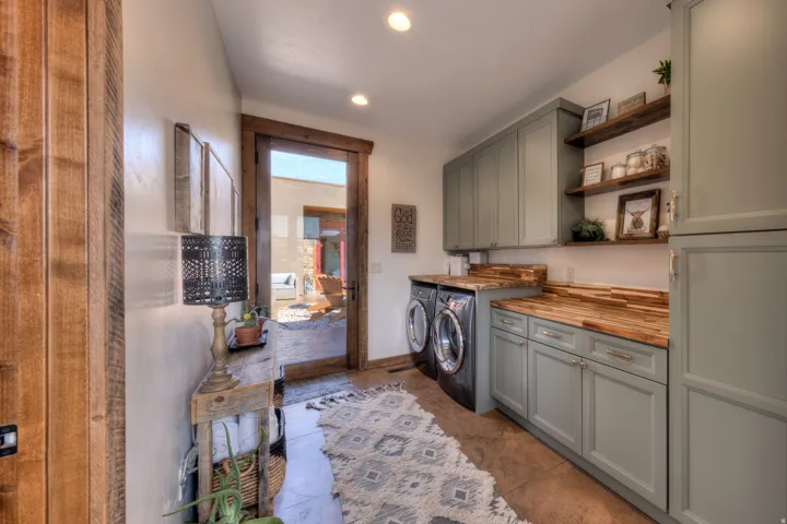 Laundry room featuring cabinet space, washer and clothes dryer, and recessed lighting