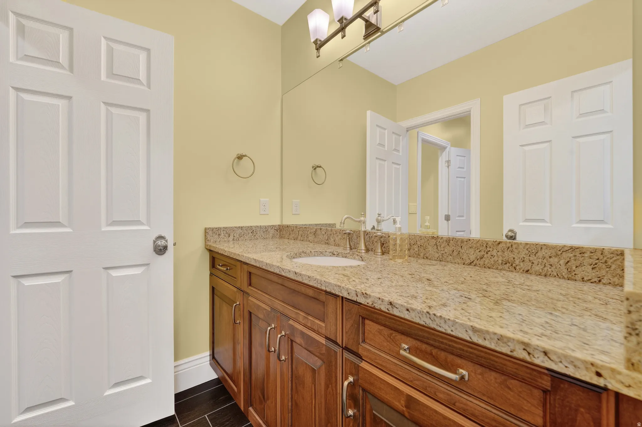 Bathroom with vanity and baseboards