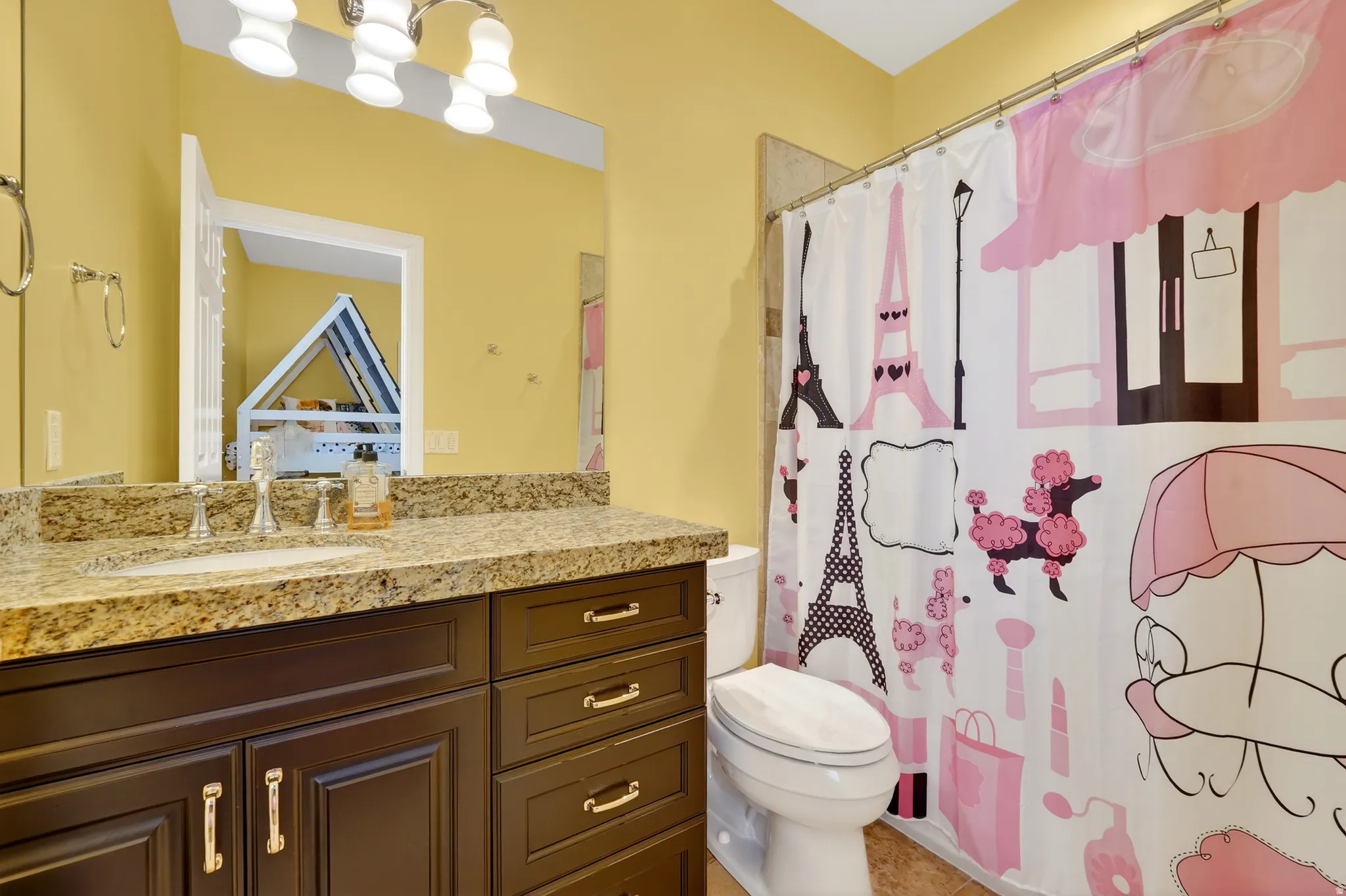 Bathroom with a shower with shower curtain and vanity
