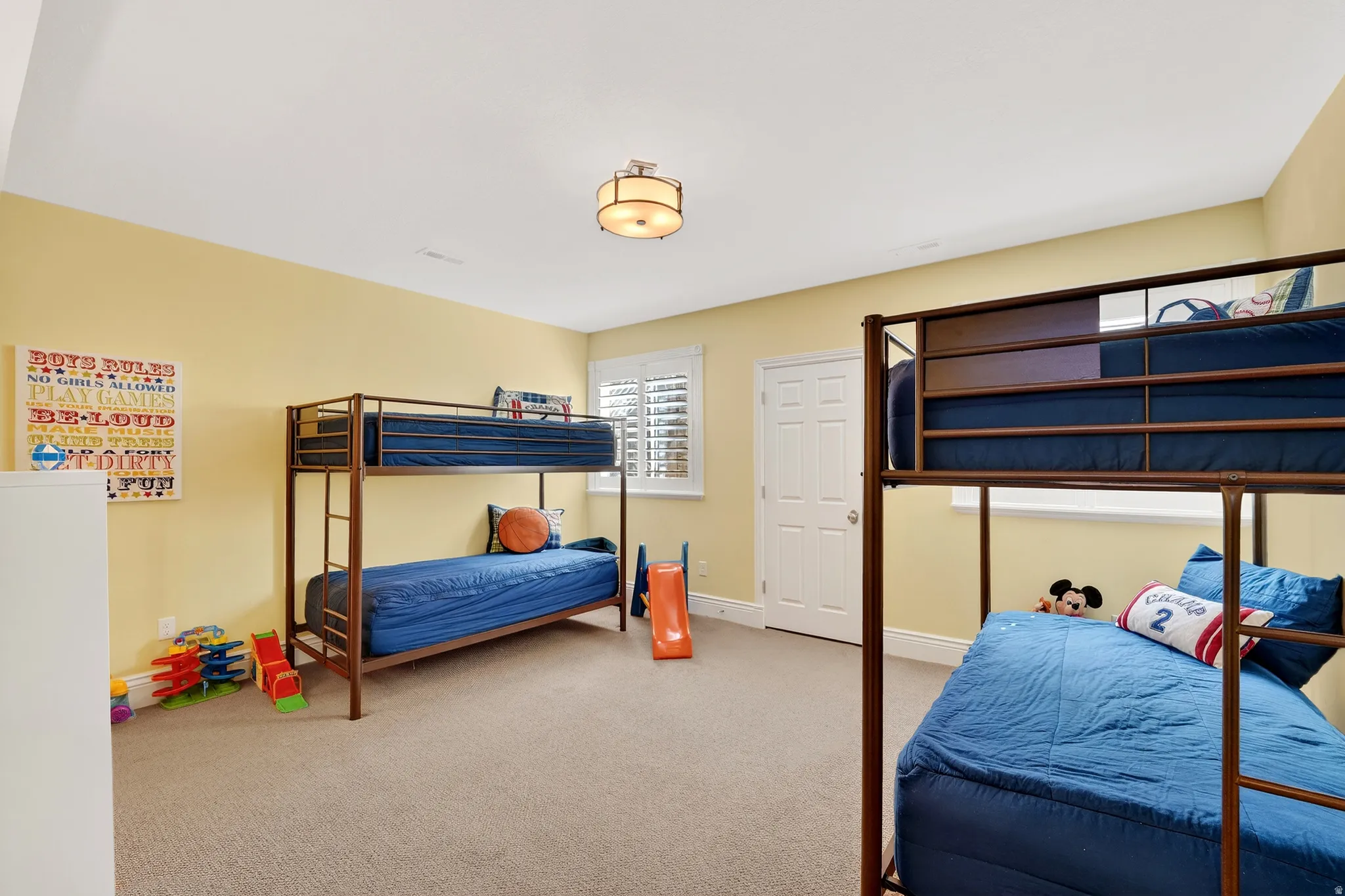 Bedroom with light carpet and baseboards
