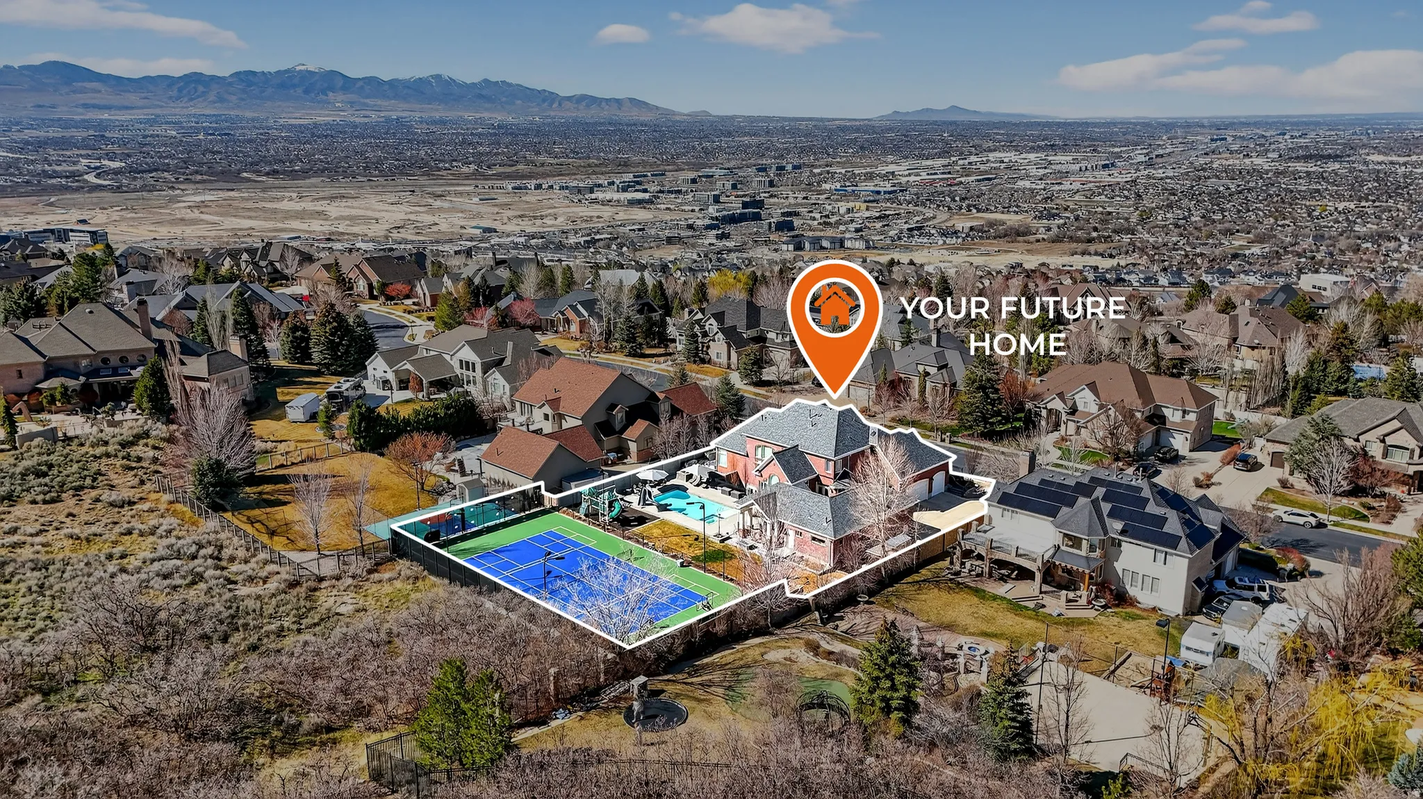 Aerial perspective of suburban area featuring mountains and a pool area