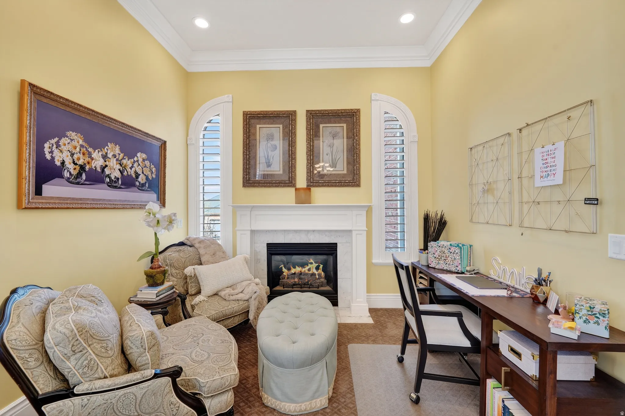 Office area with ornamental molding, a high end fireplace, and carpet flooring