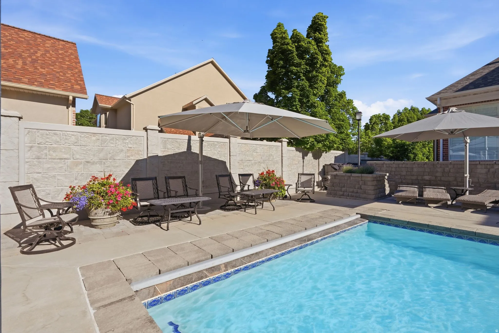 Outdoor swimming pool with included umbrellas.