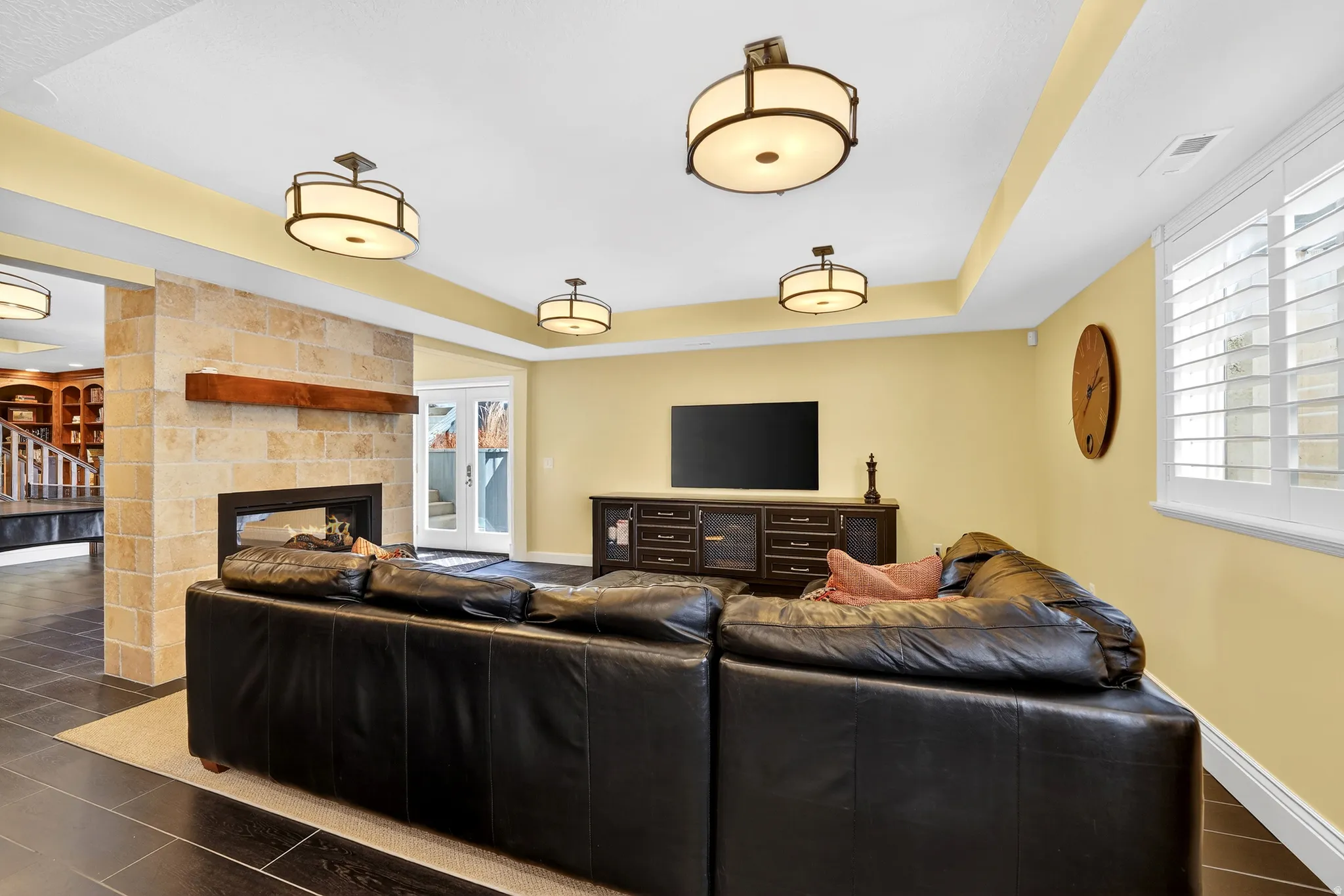 Living area with a raised ceiling and a multi sided fireplace