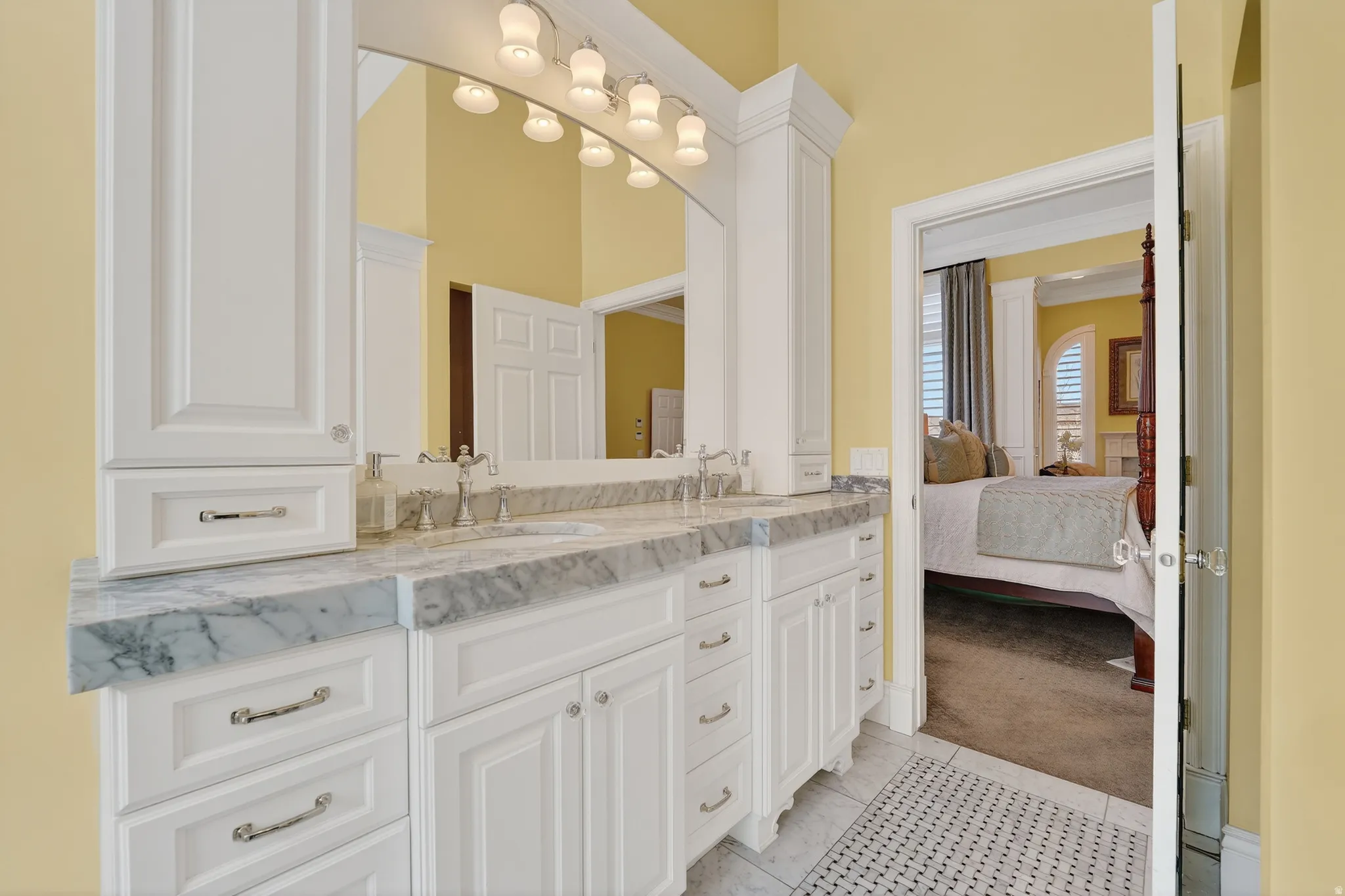 Full bath featuring double vanity, light carpet, connected bathroom, and light tile patterned floors