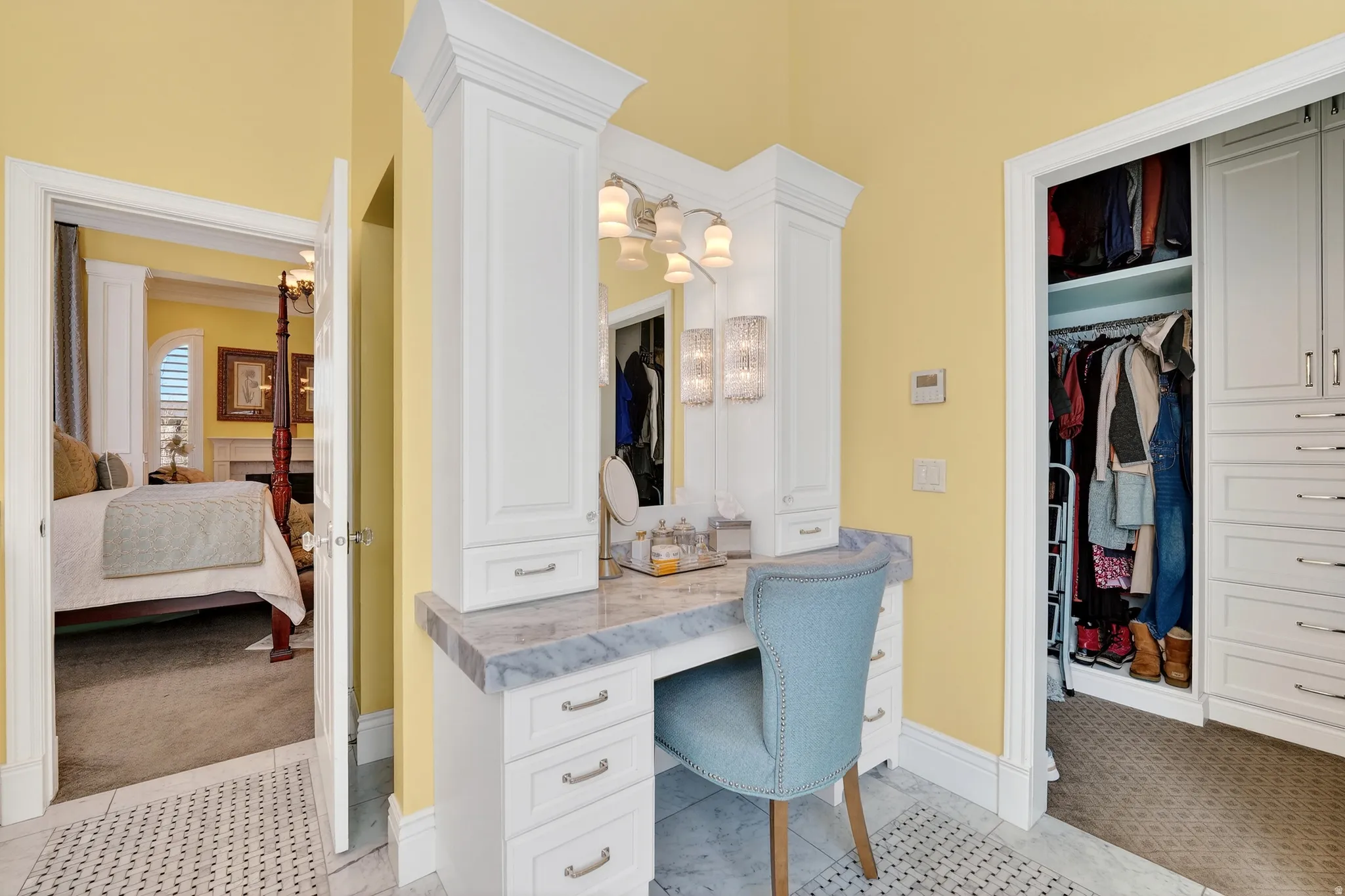 Ensuite bathroom with a walk in closet and light colored carpet