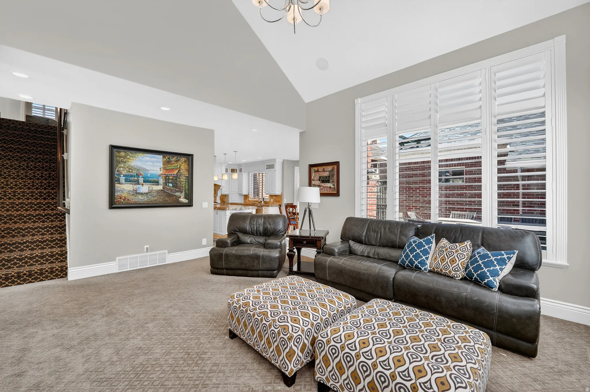 Family Room area with carpet floors and vaulted ceiling