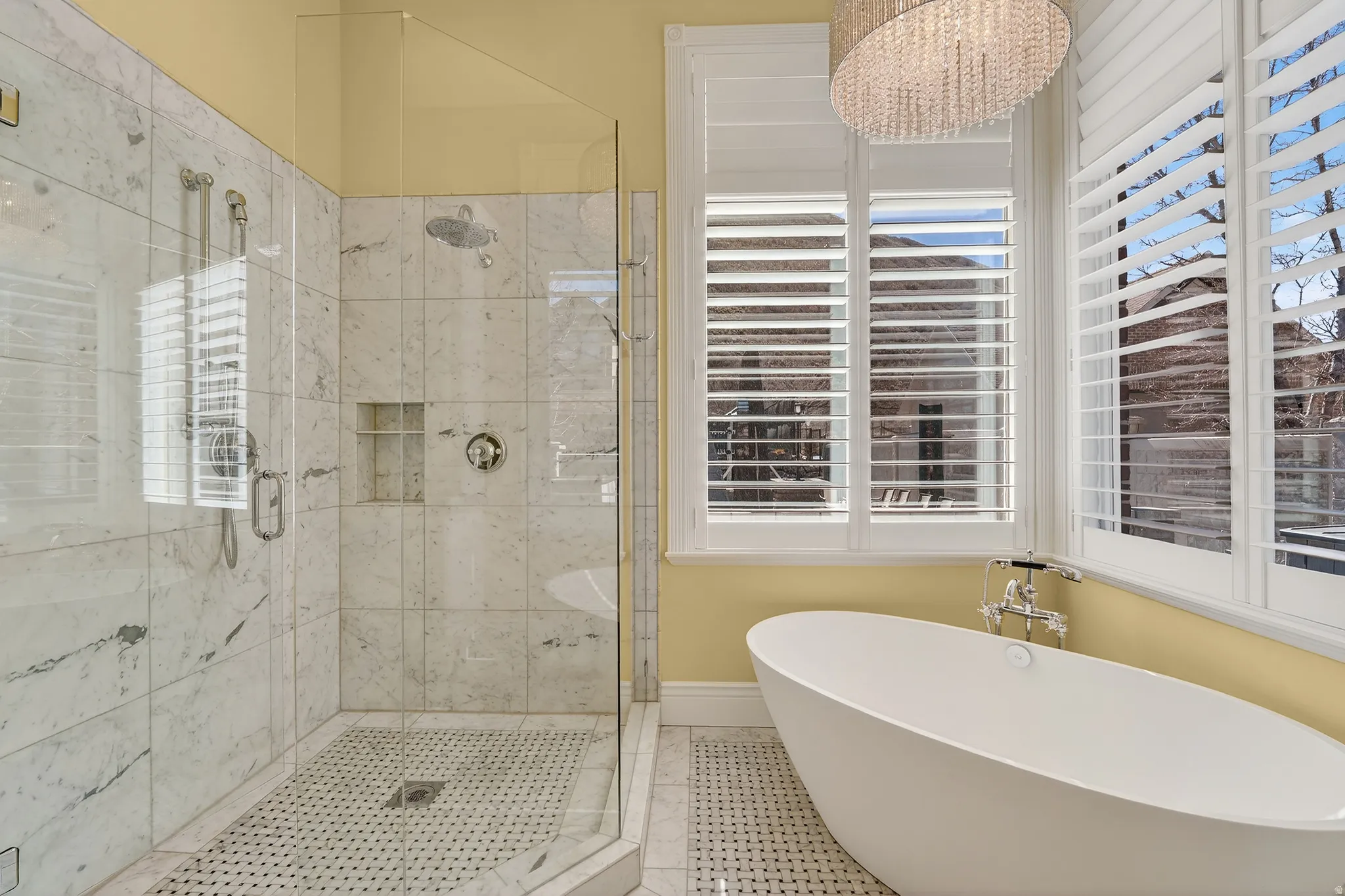 Full bathroom featuring a stall shower, a freestanding bath, and tile patterned flooring