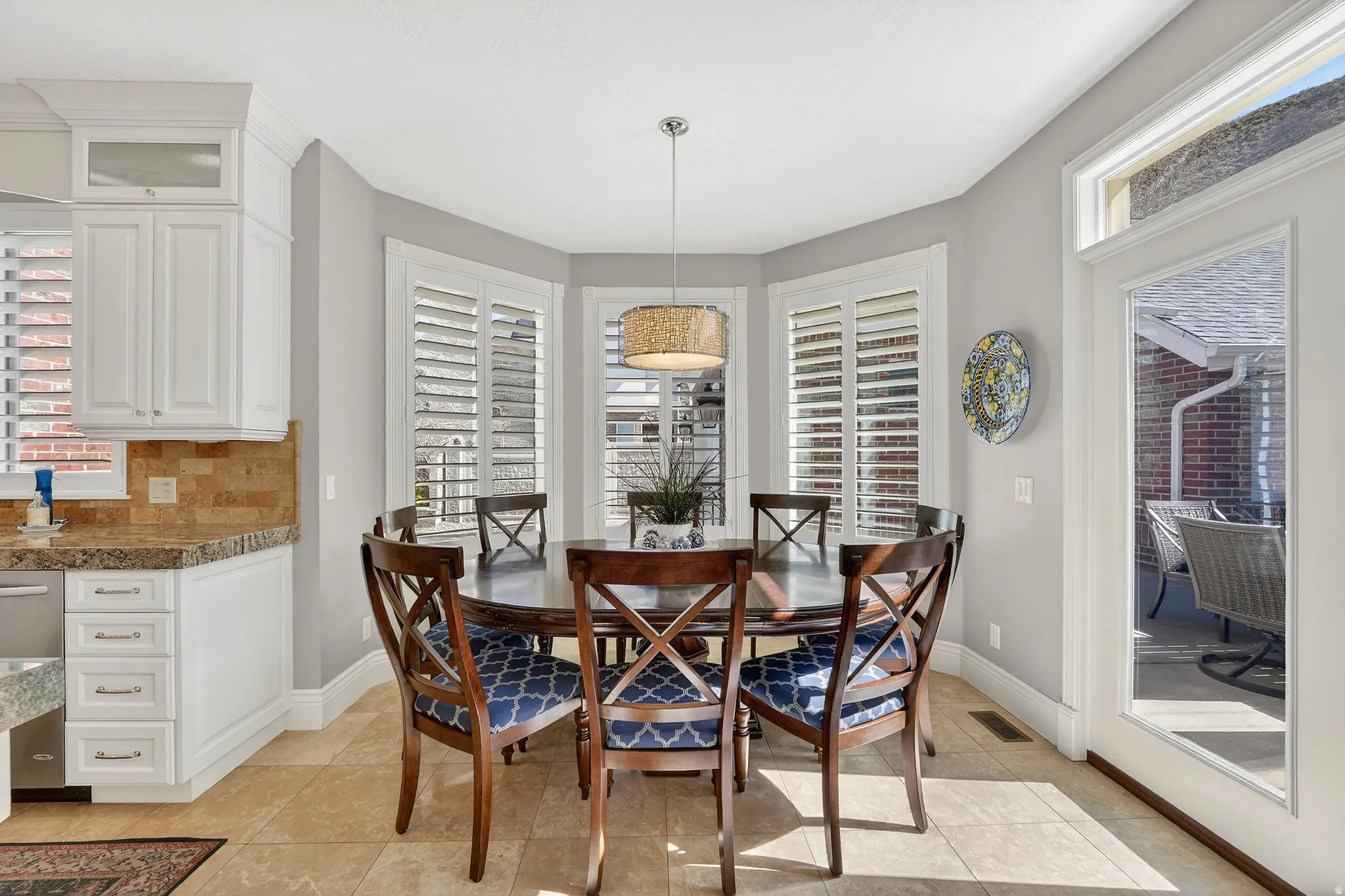 Dining area with plenty of natural light and light tile patterned flooring