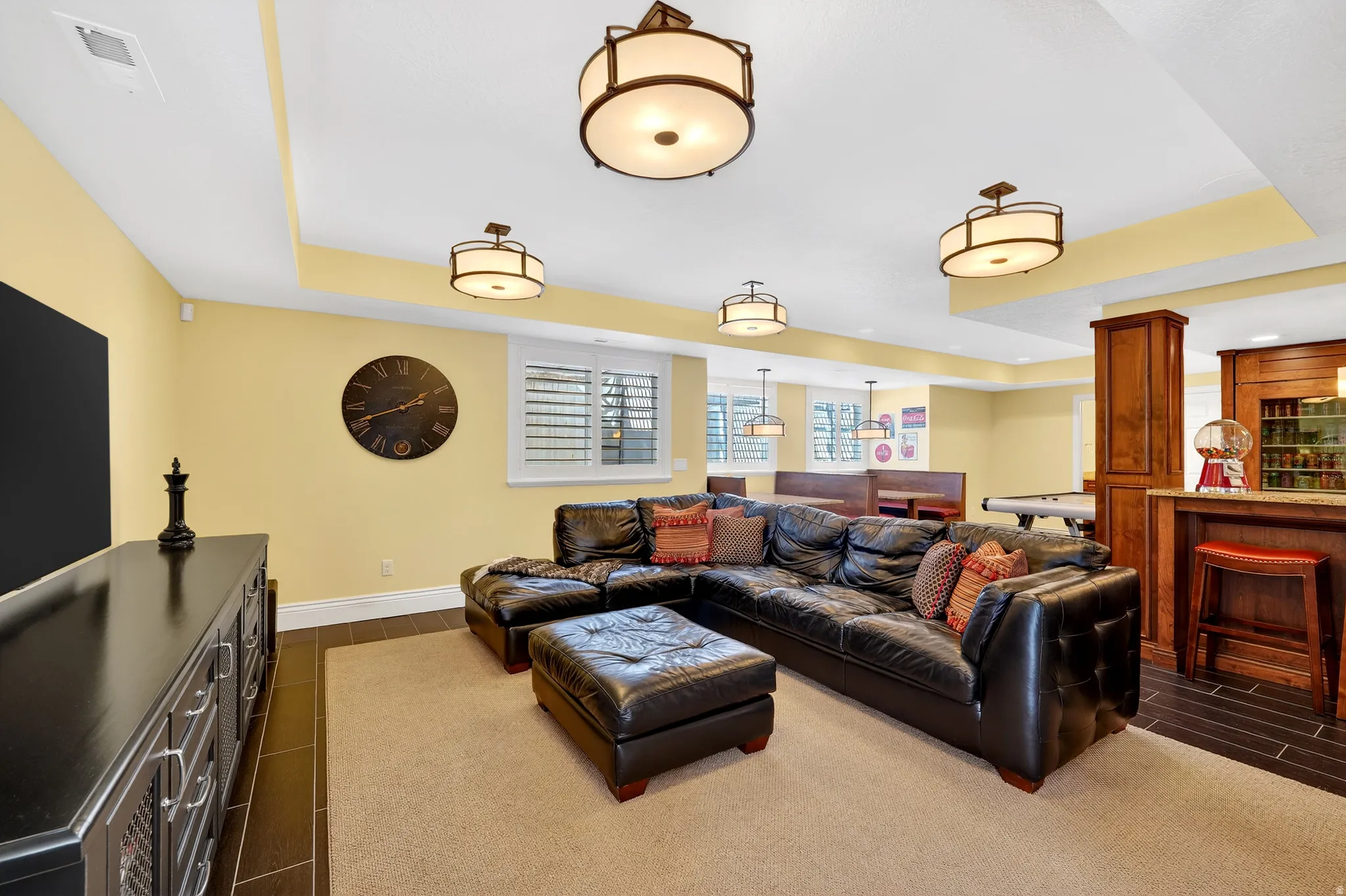Living room featuring a raised ceiling, wood tiled floors, and recessed lighting