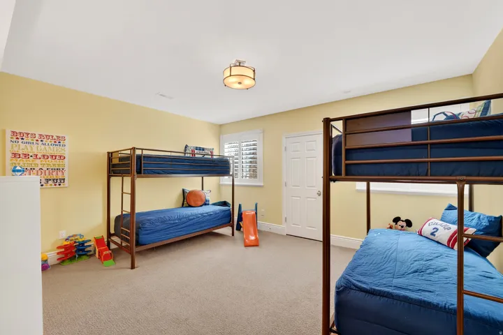 Bedroom with light carpet and baseboards