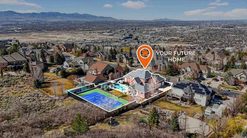 Aerial perspective of suburban area featuring mountains and a pool area