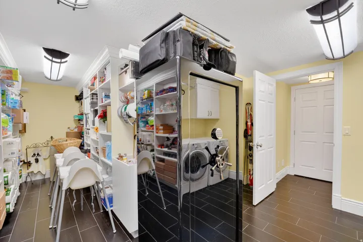 Laundry room with washer and clothes dryer, wood finish floors, cabinet space, and a textured ceiling