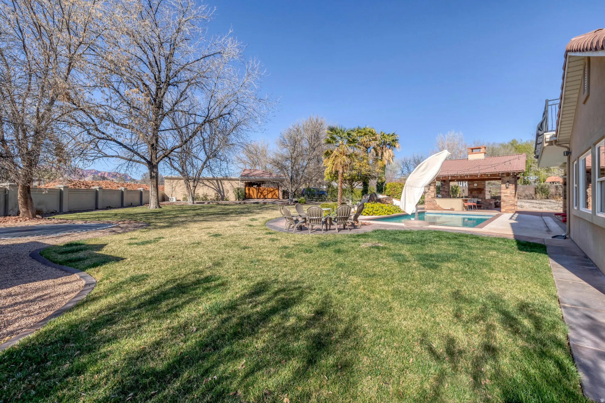 Fenced backyard with a patio area