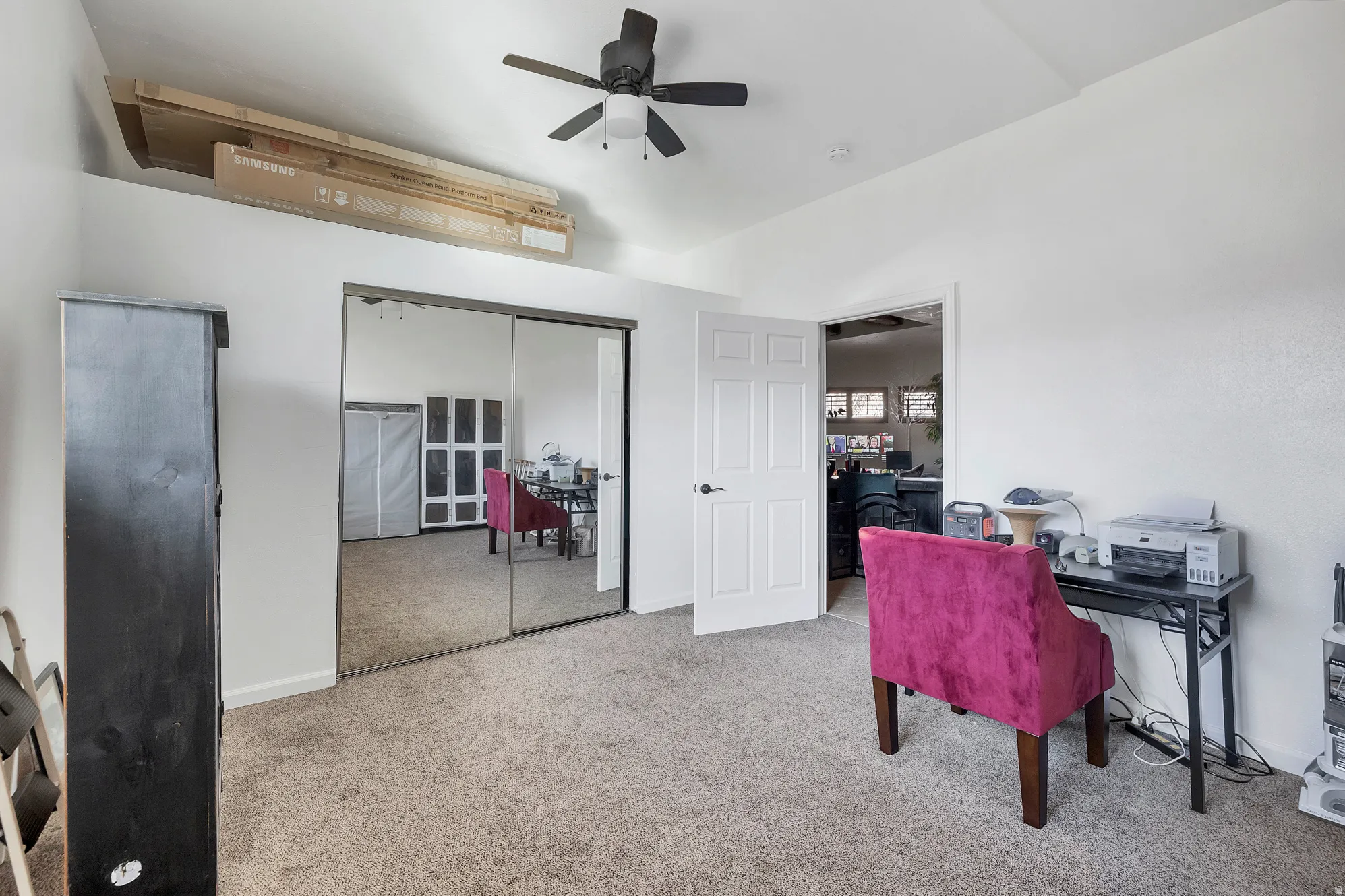 Office space featuring a ceiling fan and light carpet