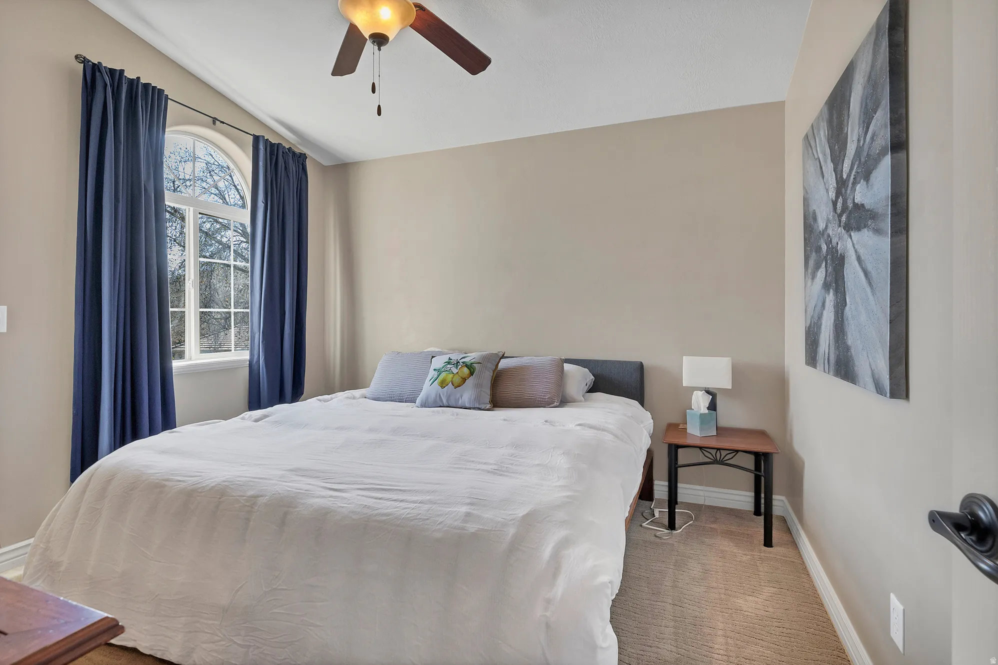 Bedroom with light colored carpet and ceiling fan