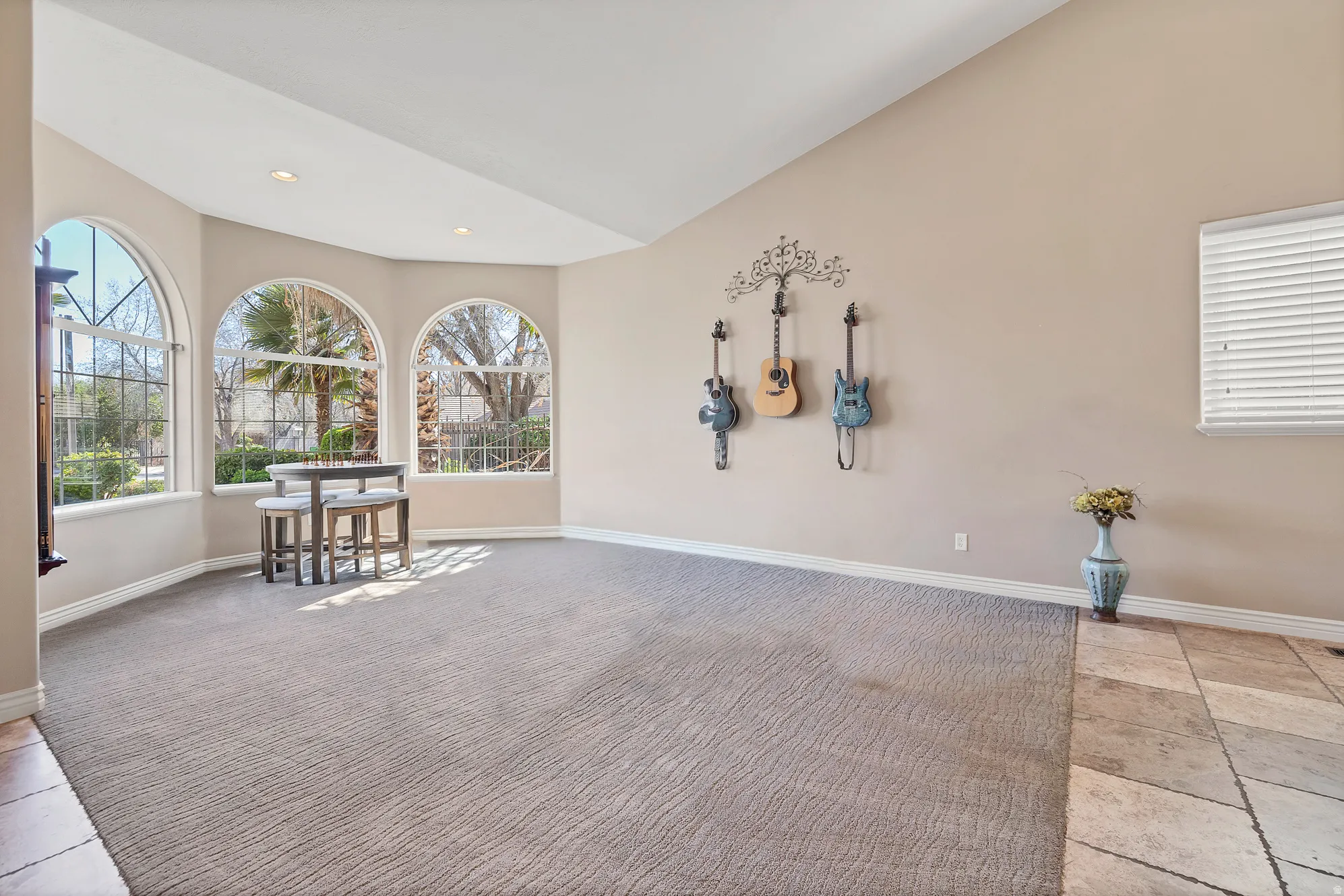 Spare room with light colored carpet, lofted ceiling, and recessed lighting