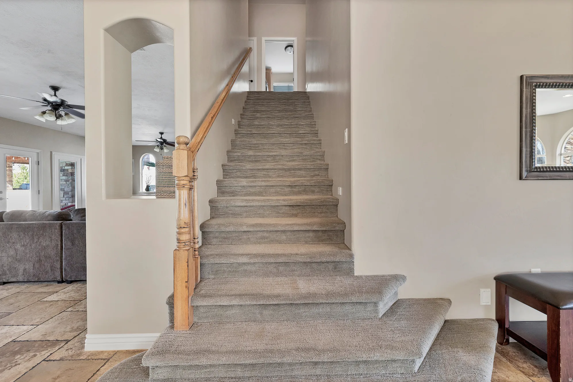 Stairway featuring baseboards and ceiling fan