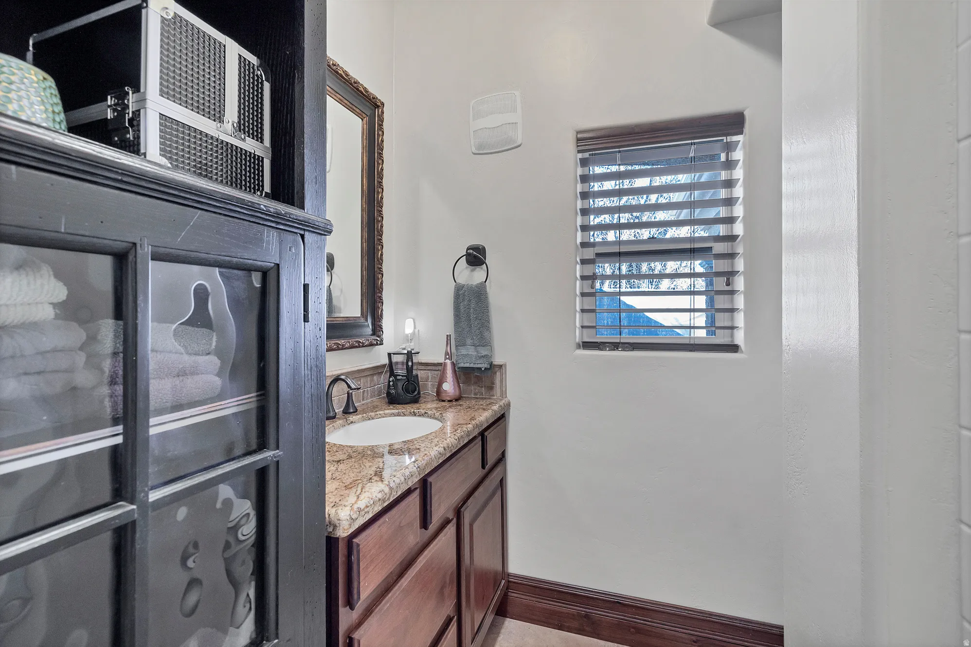 Bathroom featuring vanity and baseboards
