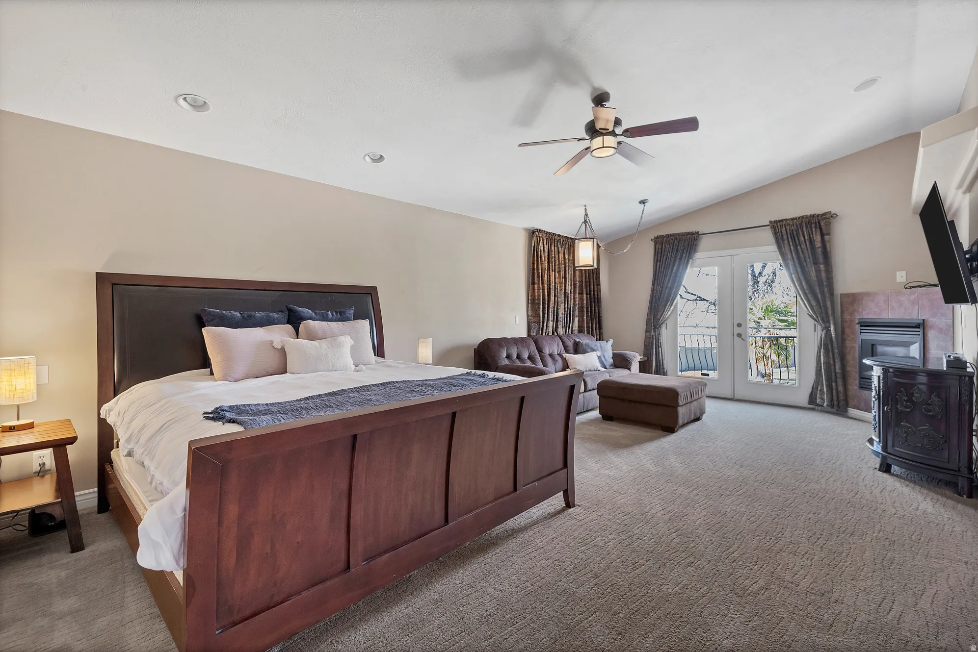 Bedroom featuring french doors, carpet flooring, access to outside, a ceiling fan, and lofted ceiling