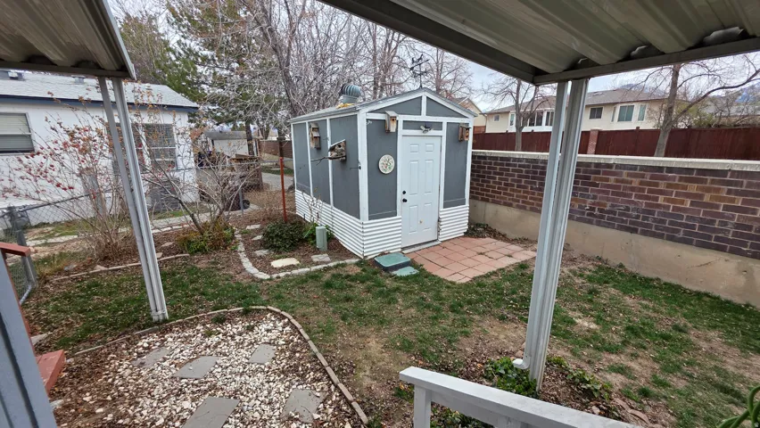 Fenced backyard with an outdoor structure