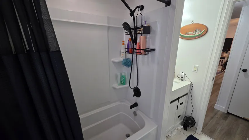 Bathroom featuring shower / bath combo and vanity