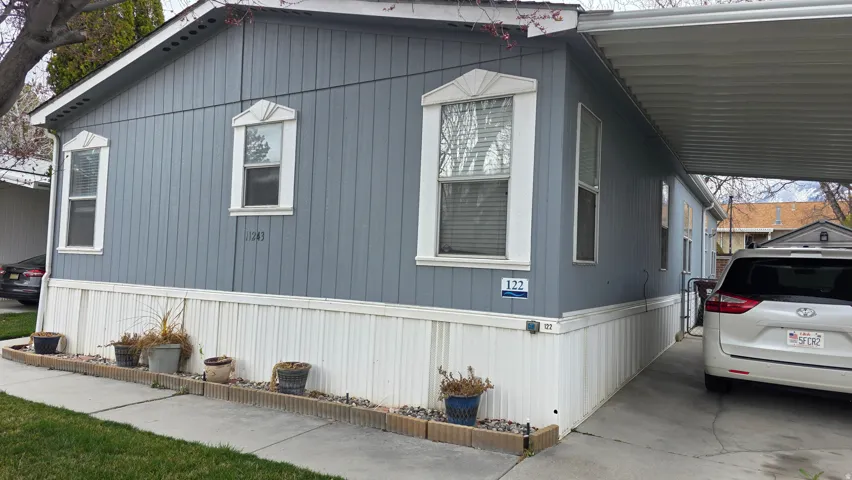 View of side of property with a carport