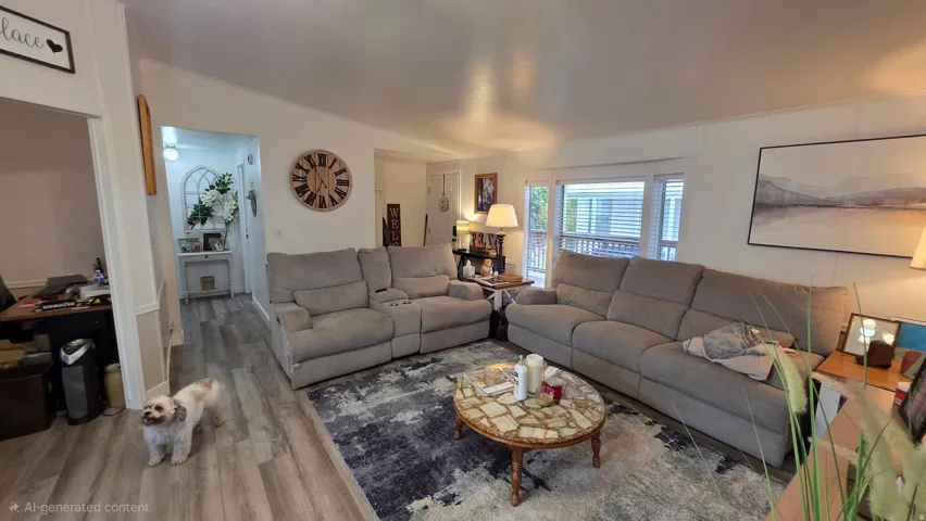 Living room featuring wood finished floors and lofted ceiling