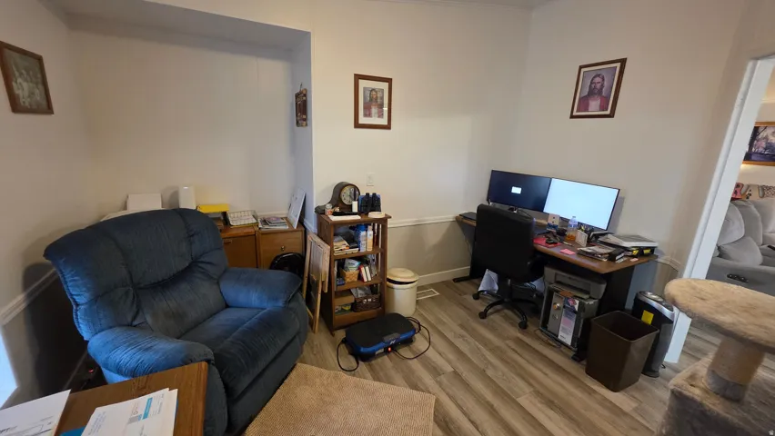 Office area with wood finished floors and baseboards