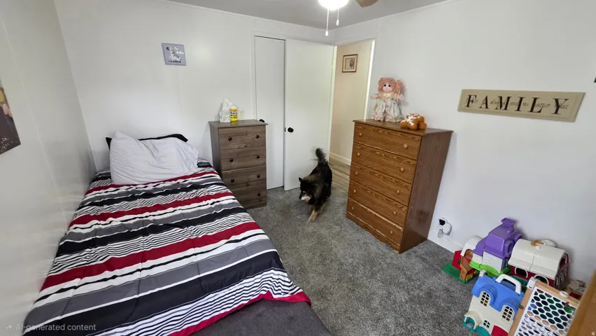 Bedroom with dark colored carpet and a closet
