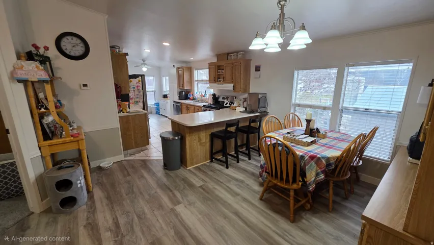 Dining space featuring light wood-type flooring, hanging lights, ceiling fan, and crown molding