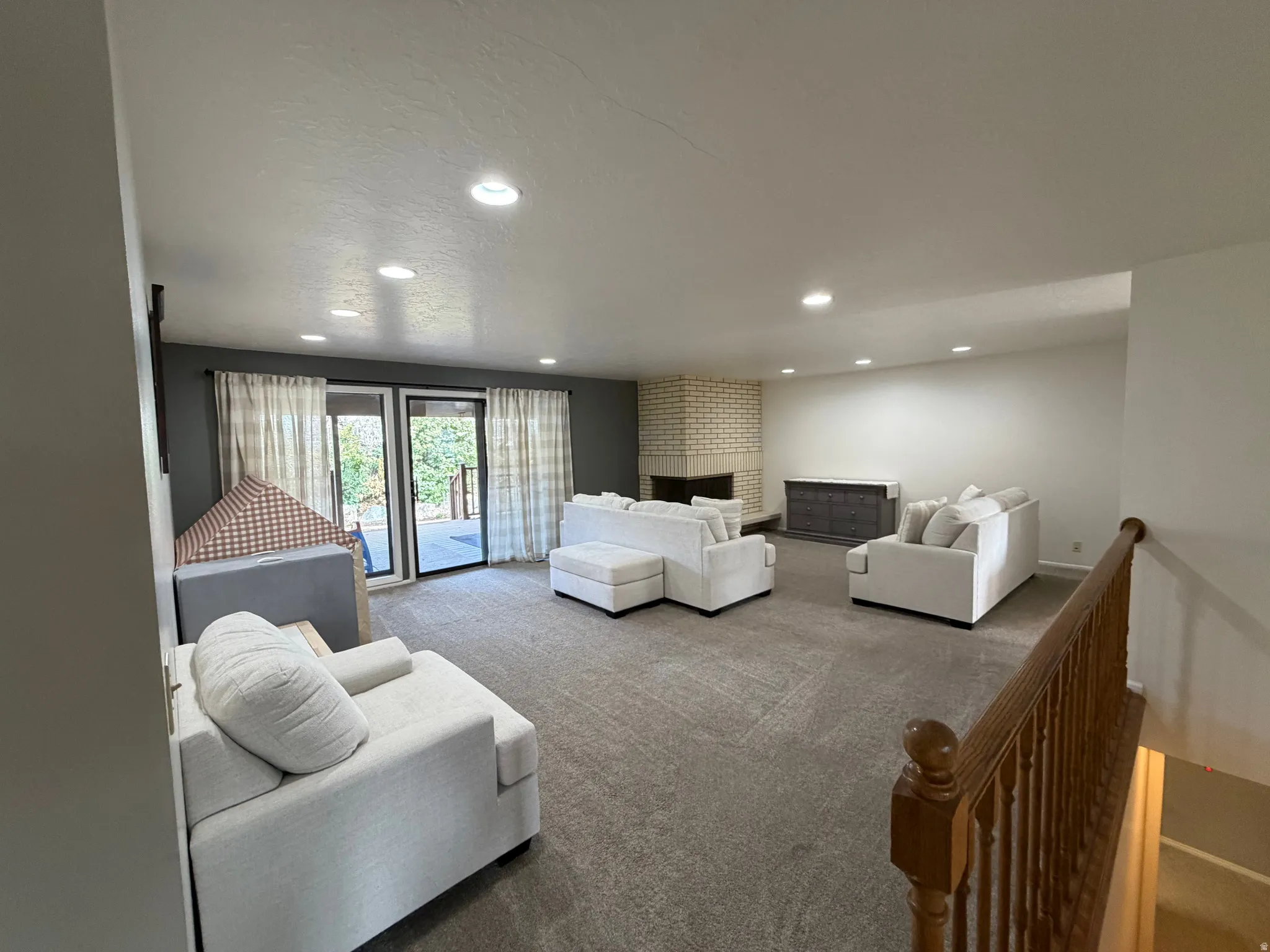 Carpeted living room with recessed lighting