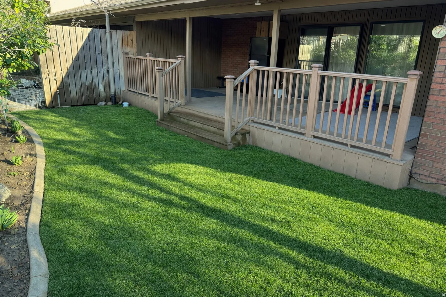 View of yard featuring a deck and what grass will look like
