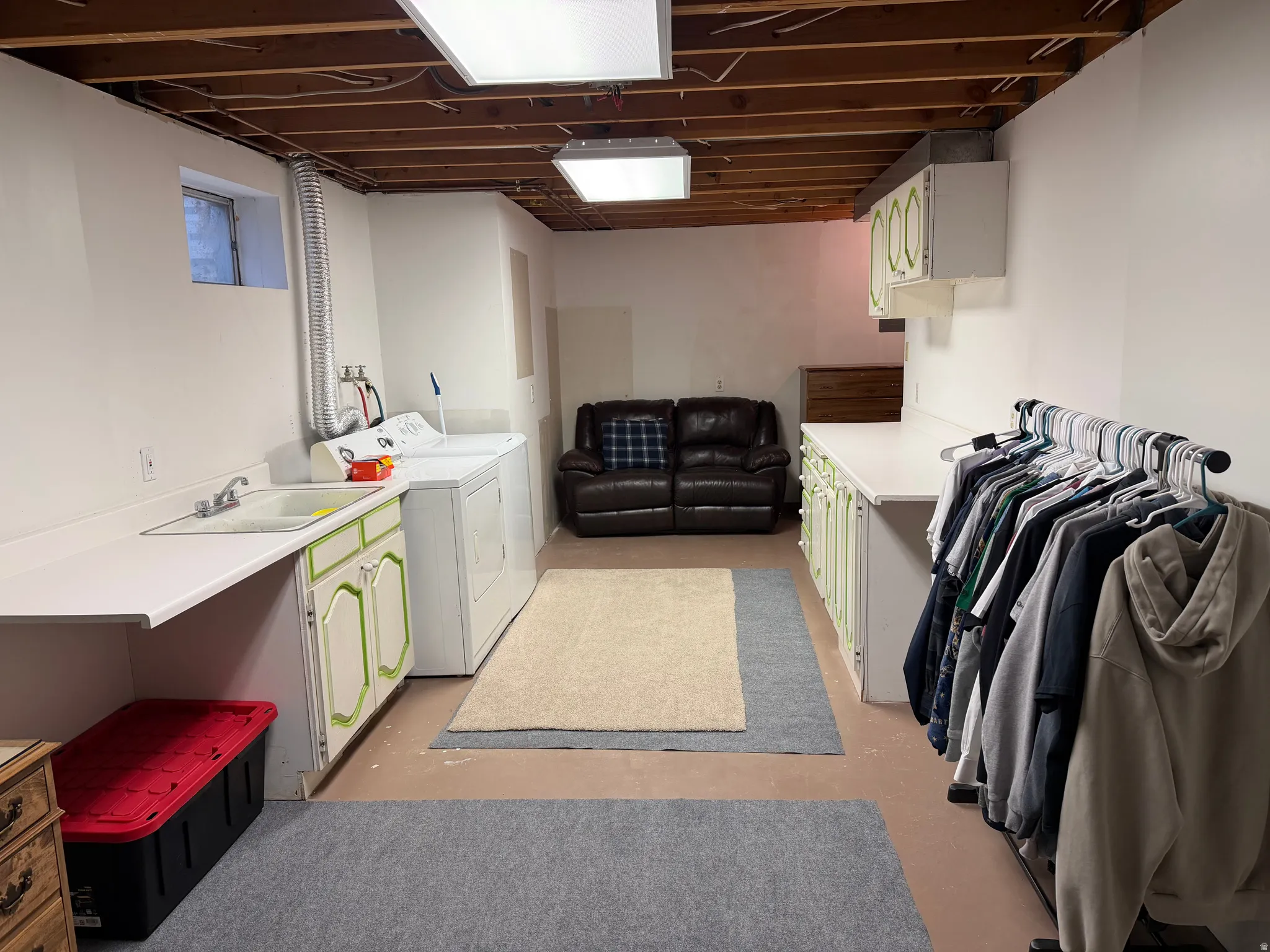 Laundry room with cabinet space, separate washer and dryer, and concrete floors
