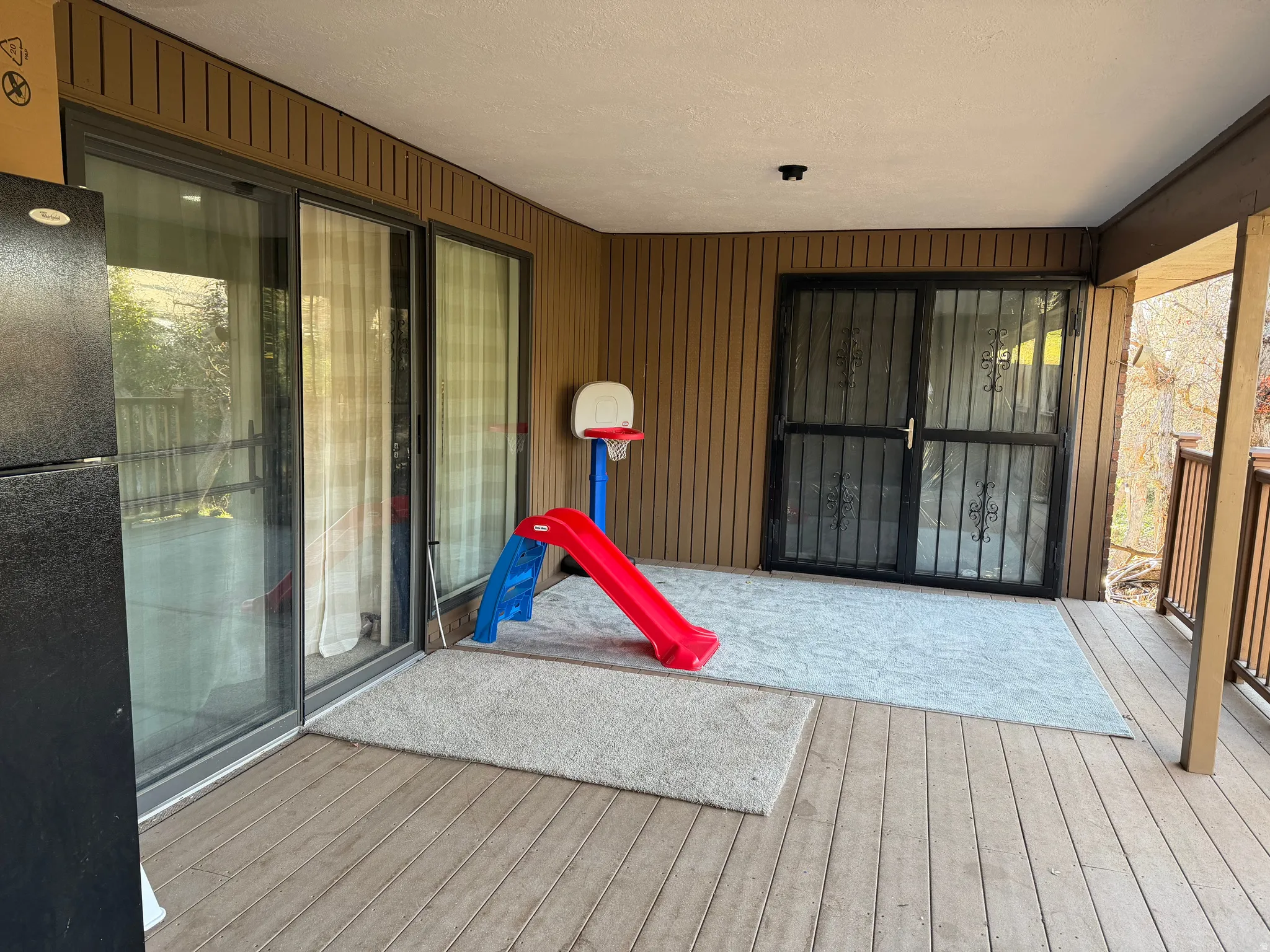 View of exterior entry featuring a wooden deck