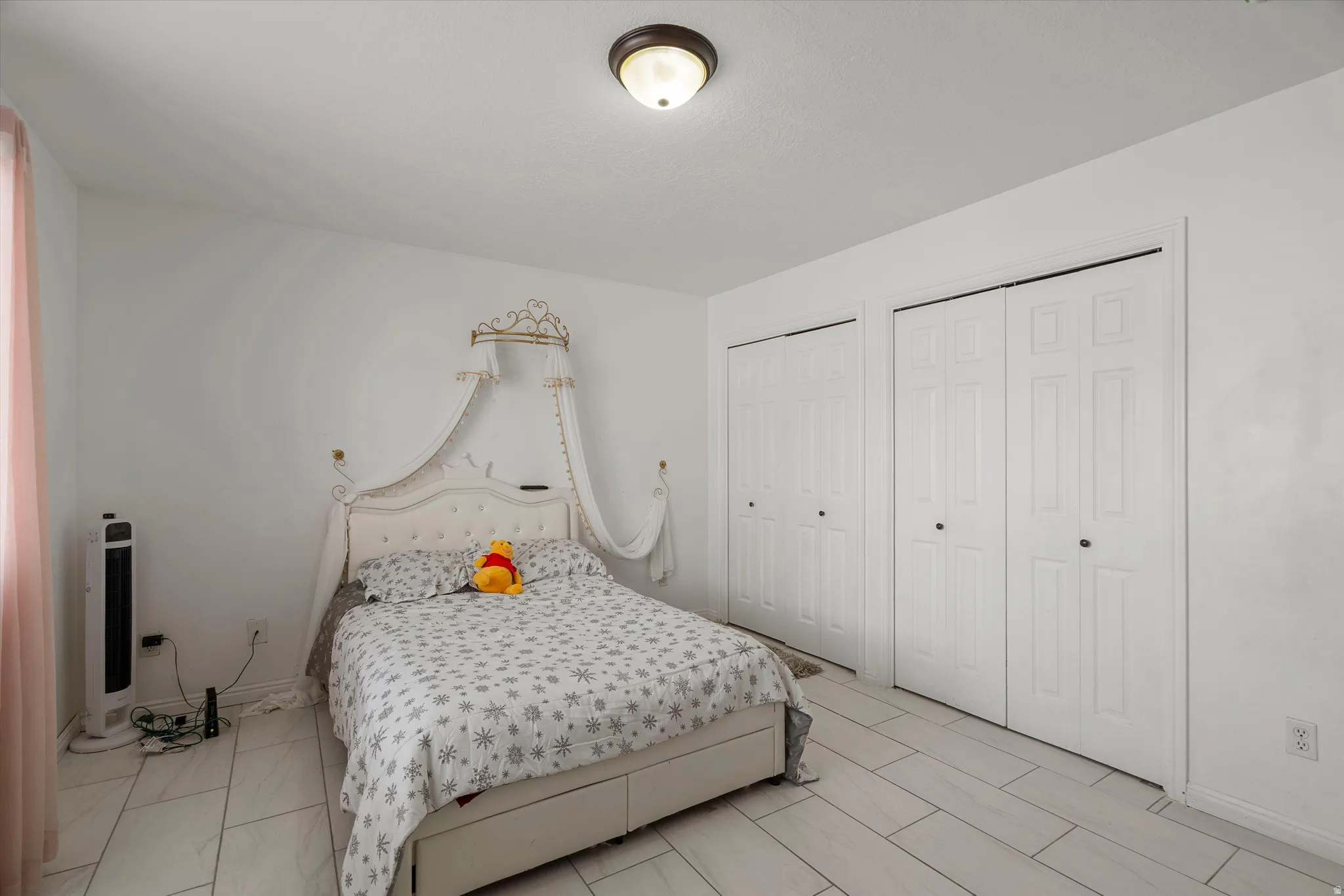 Bedroom featuring multiple closets and baseboards