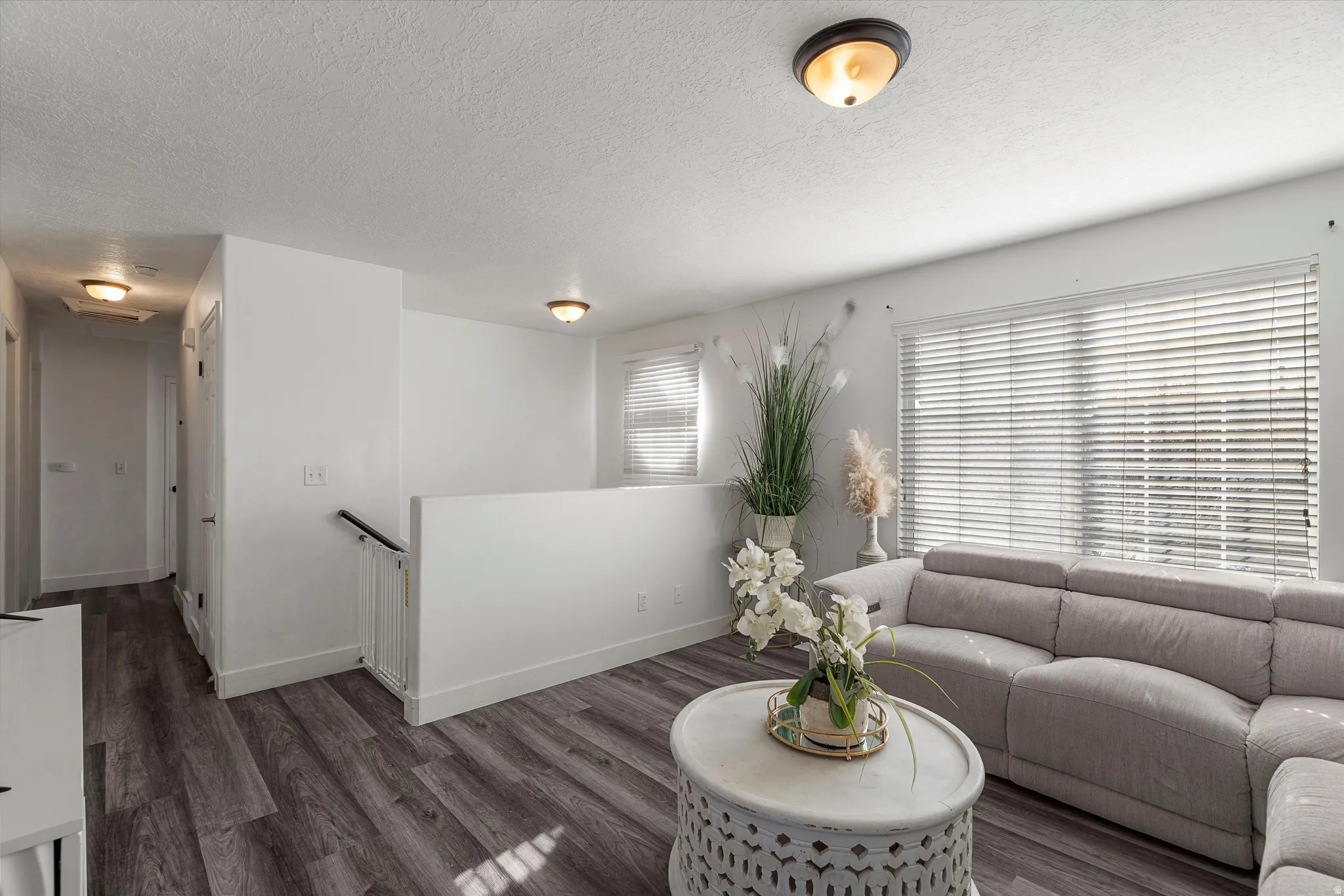 Living room with wood finished floors and a textured ceiling