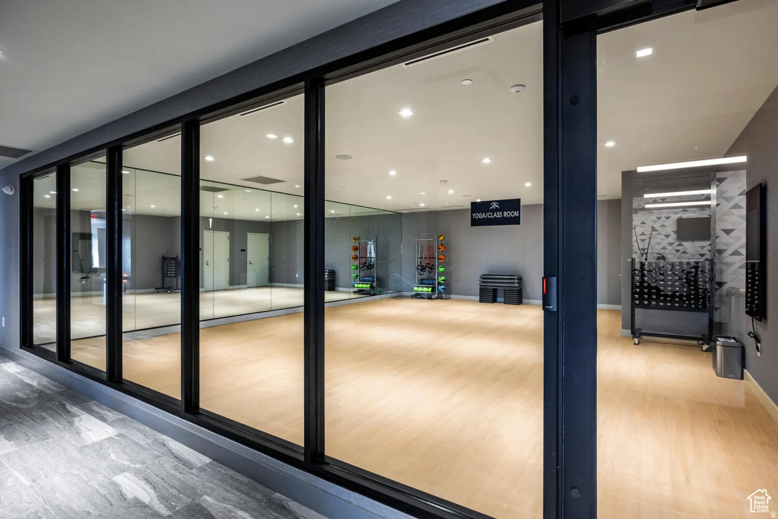 Doorway with wood finished floors and recessed lighting